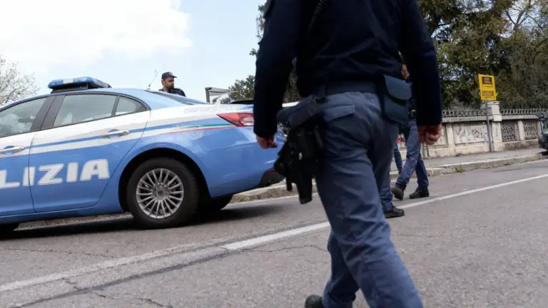 Agenti di polizia vicino a un'auto della polizia in una strada urbana