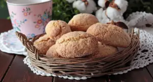 Cestino di biscottoni da inzuppo senza burro su tavolo in legno con tazza rosa